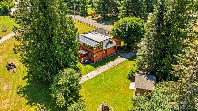 a bedroom with a bed and large windows
