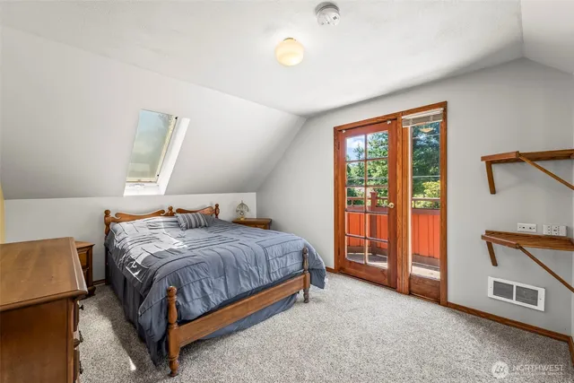 a bedroom with a bed and a table