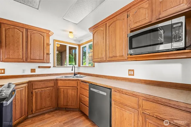 a kitchen with a sink stove and microwave