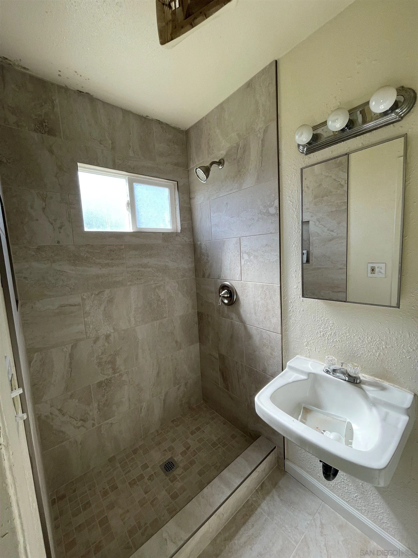 9447 Pennywood Road Santee, CA 92071 - Photo 3 of 6 a bathroom with a sink a toilet and shower