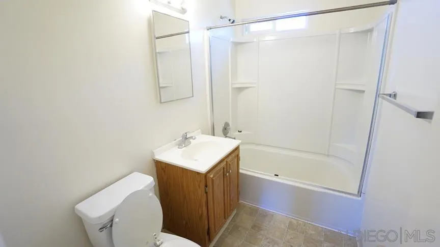9447 Pennywood Road Santee, CA 92071 - Photo 4 of 6 a bathroom with a sink a toilet and shower
