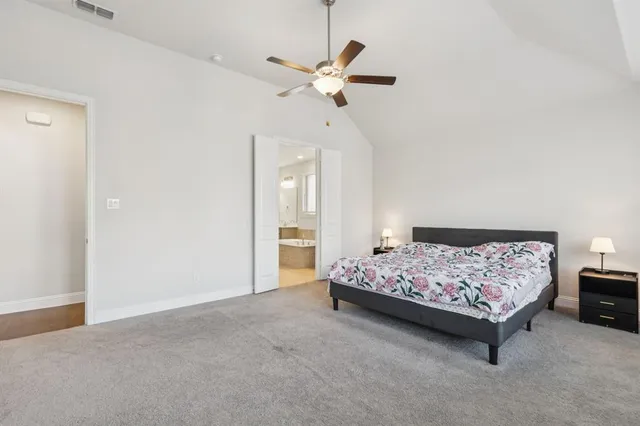 a bed room with a bed and a ceiling fan