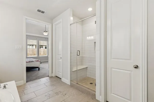 a bathroom with a shower and a sink