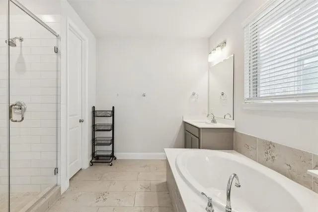 a bathroom with a bathtub and a sink