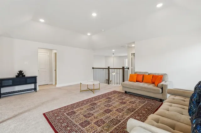 a living room with furniture and a rug