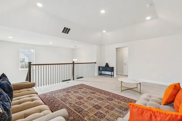 a bedroom with furniture and a rug