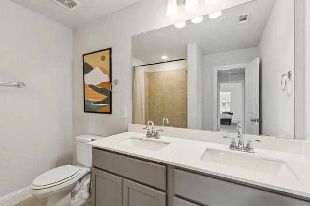 a bathroom with a toilet a sink and mirror