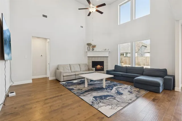 a living room with furniture a fireplace and a flat screen tv