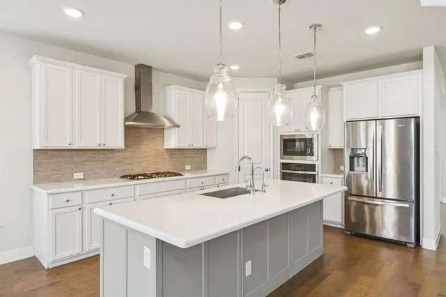 a kitchen with a sink stainless steel appliances and cabinets
