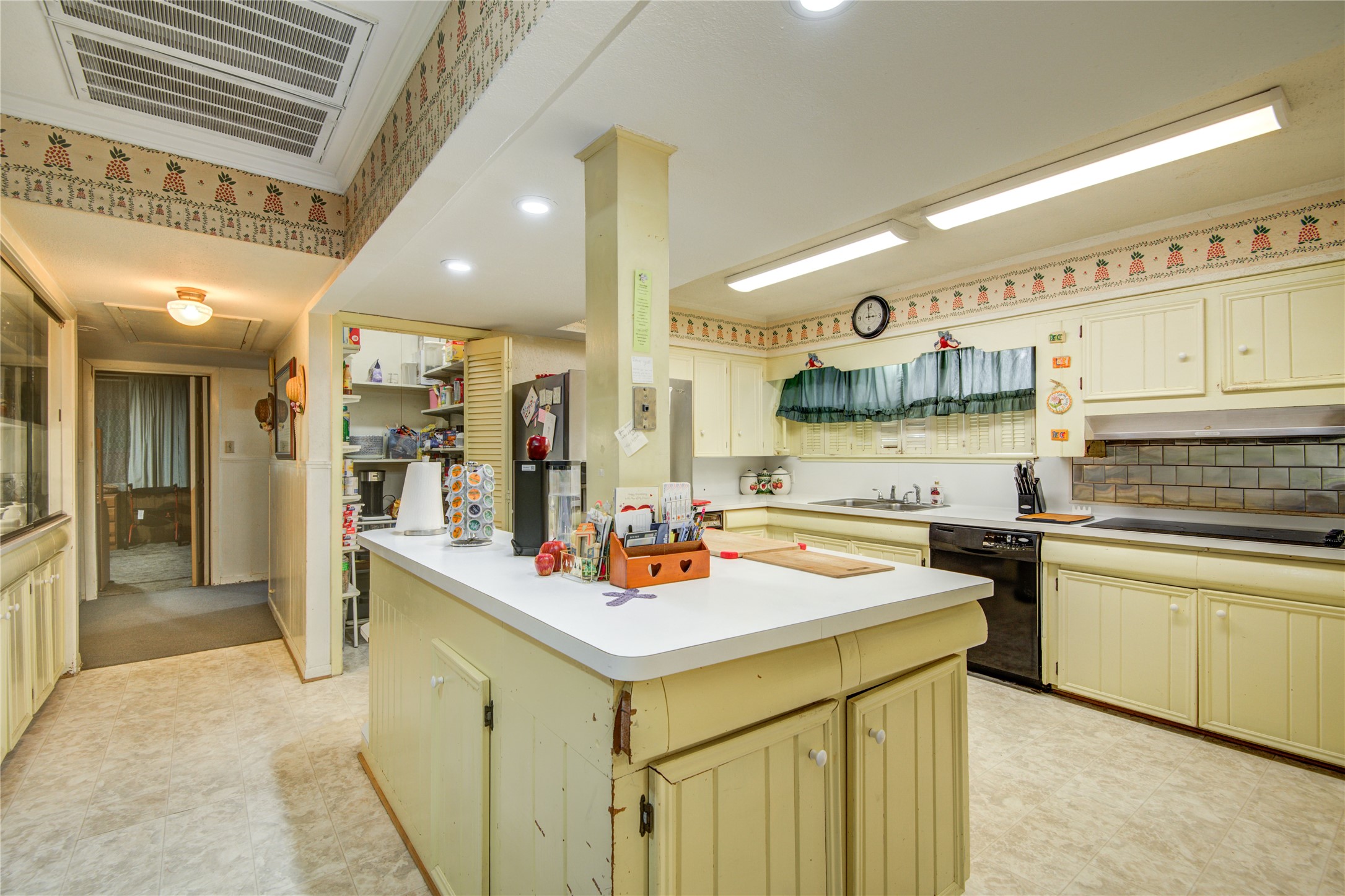 1414 West 9th Street Freeport, TX 77541 - Photo 14 of 50 a kitchen with a sink a stove and chairs