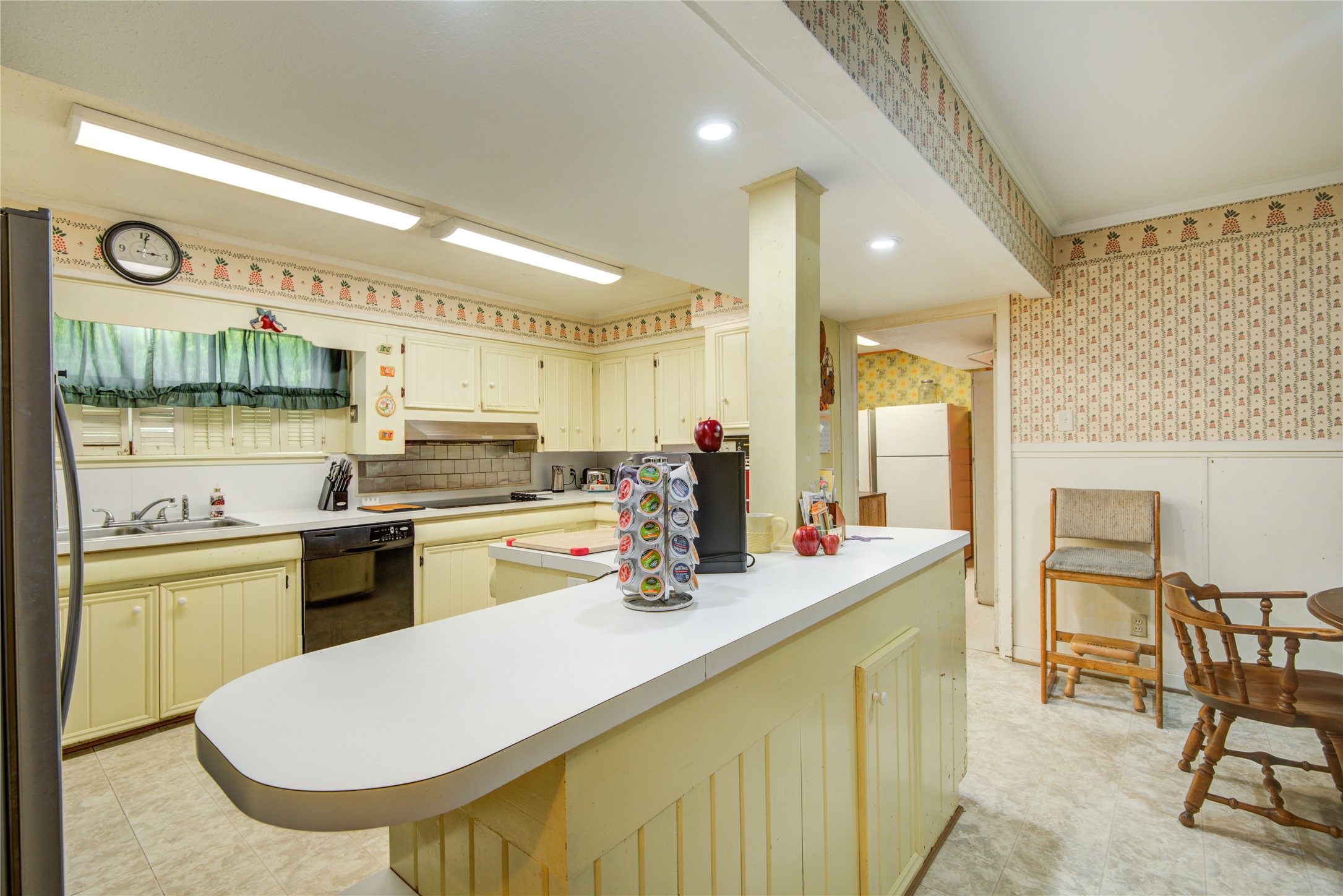 1414 West 9th Street Freeport, TX 77541 - Photo 15 of 50 a kitchen with stainless steel appliances kitchen island granite countertop a sink and cabinets