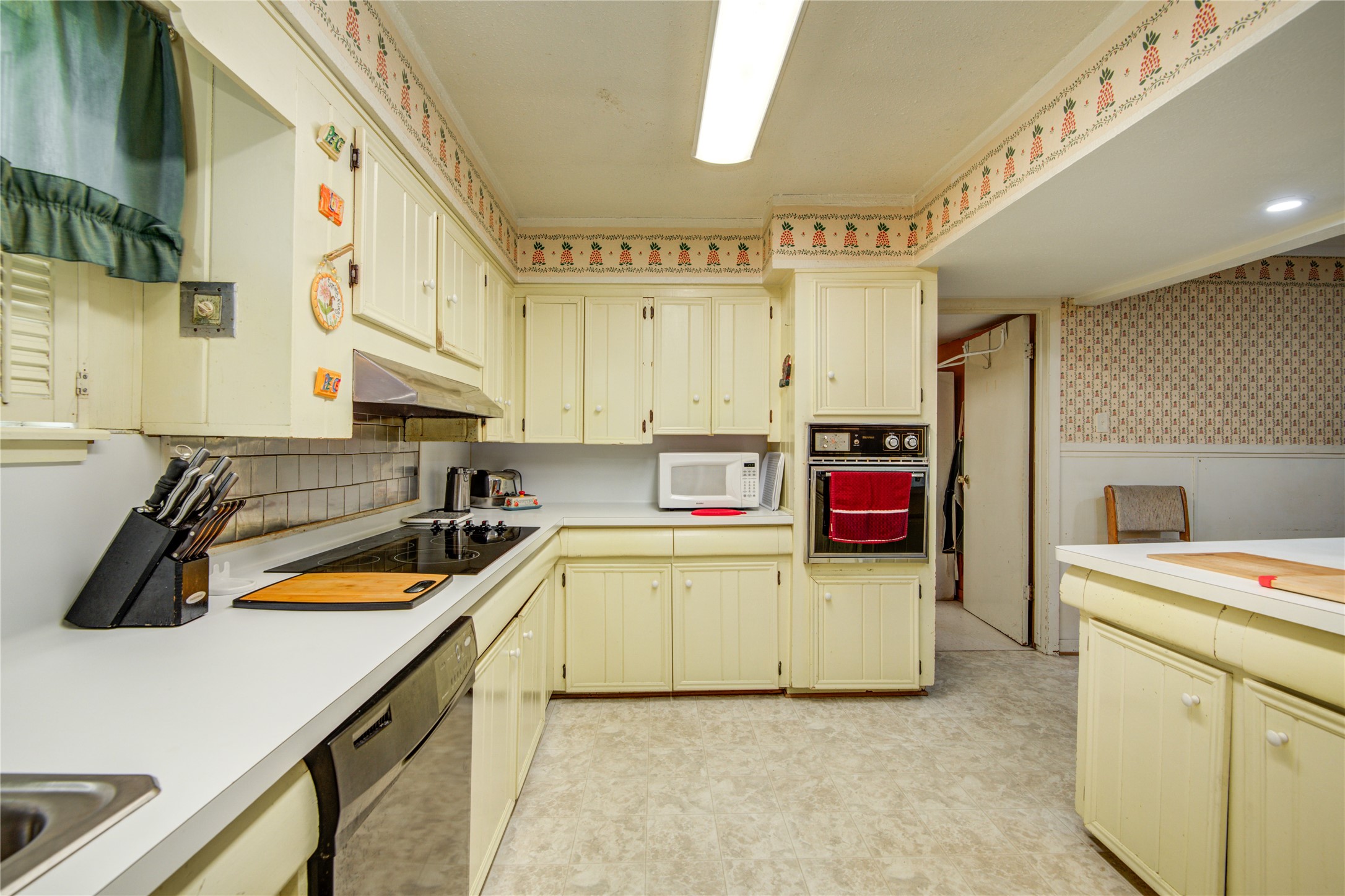1414 West 9th Street Freeport, TX 77541 - Photo 17 of 50 a kitchen with stainless steel appliances a sink and a refrigerator