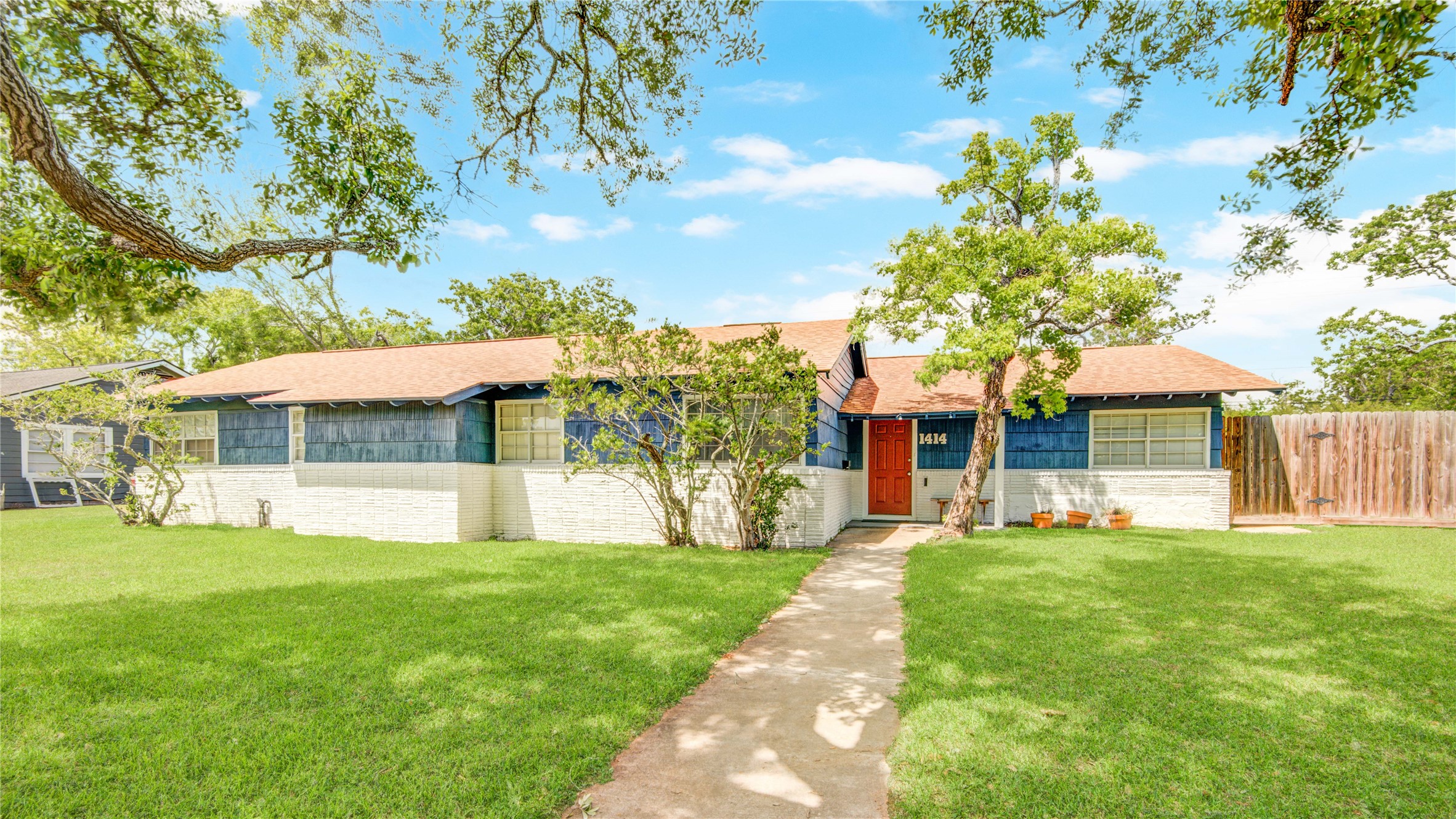 1414 West 9th Street Freeport, TX 77541 - Photo 2 of 50 a front view of a house with a yard and trees