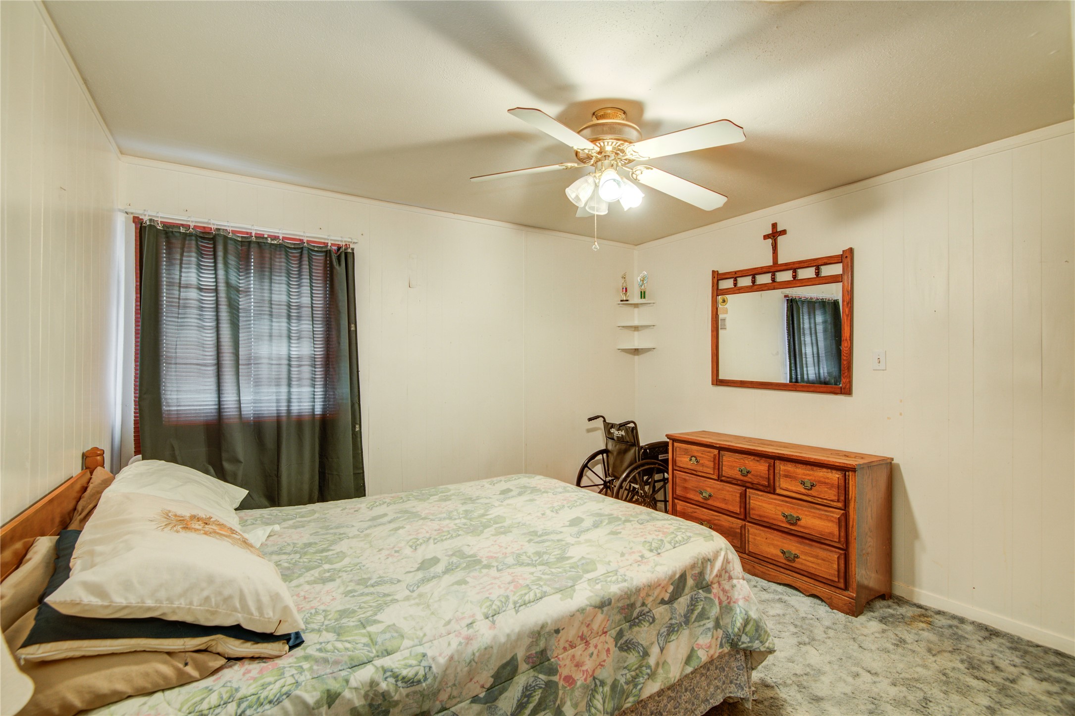 1414 West 9th Street Freeport, TX 77541 - Photo 25 of 50 a bedroom with a bed and a chandelier