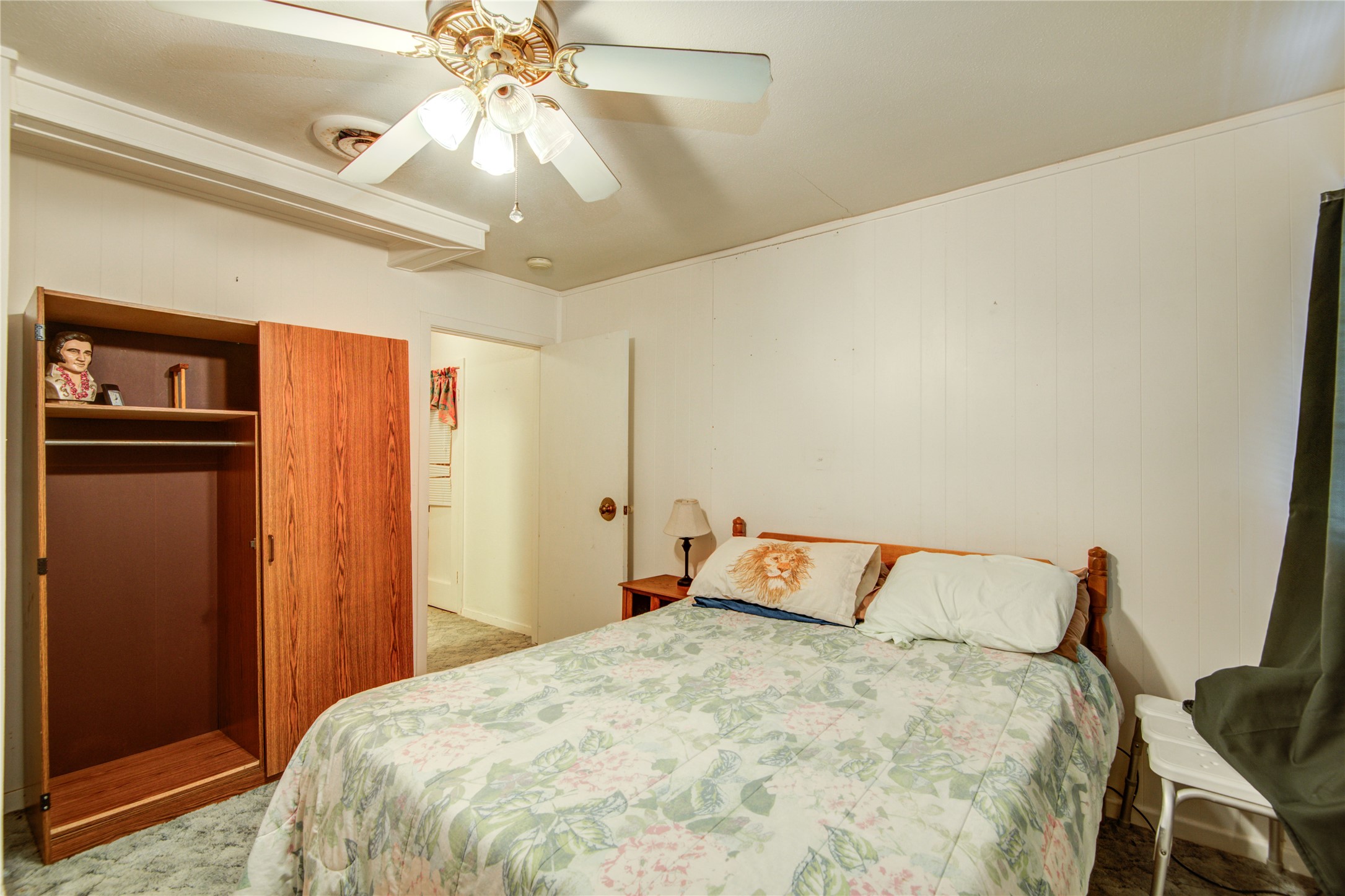 1414 West 9th Street Freeport, TX 77541 - Photo 26 of 50 a bedroom with a bed and a chandelier