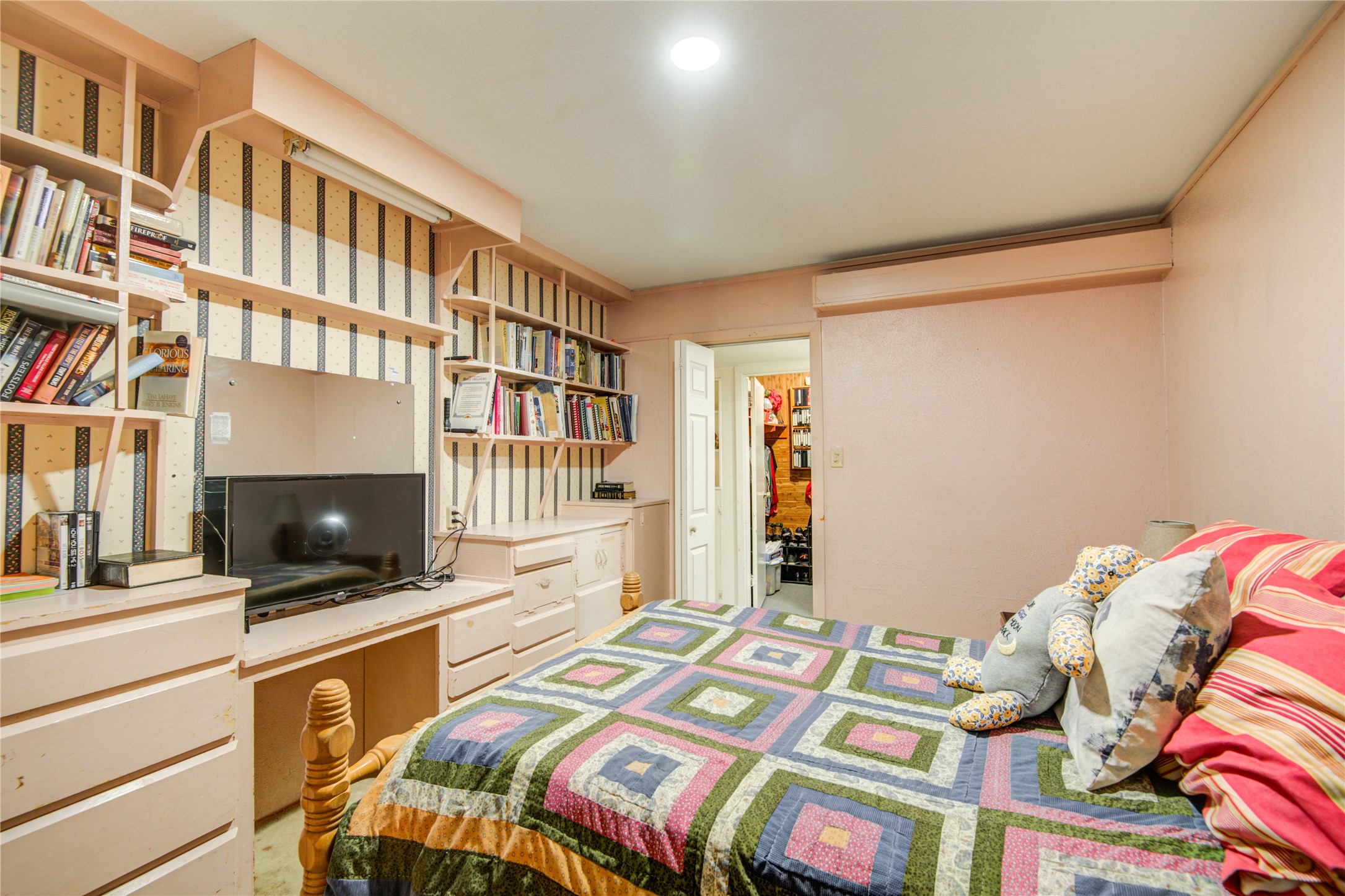 1414 West 9th Street Freeport, TX 77541 - Photo 28 of 50 a bedroom with a bed and a flat screen tv