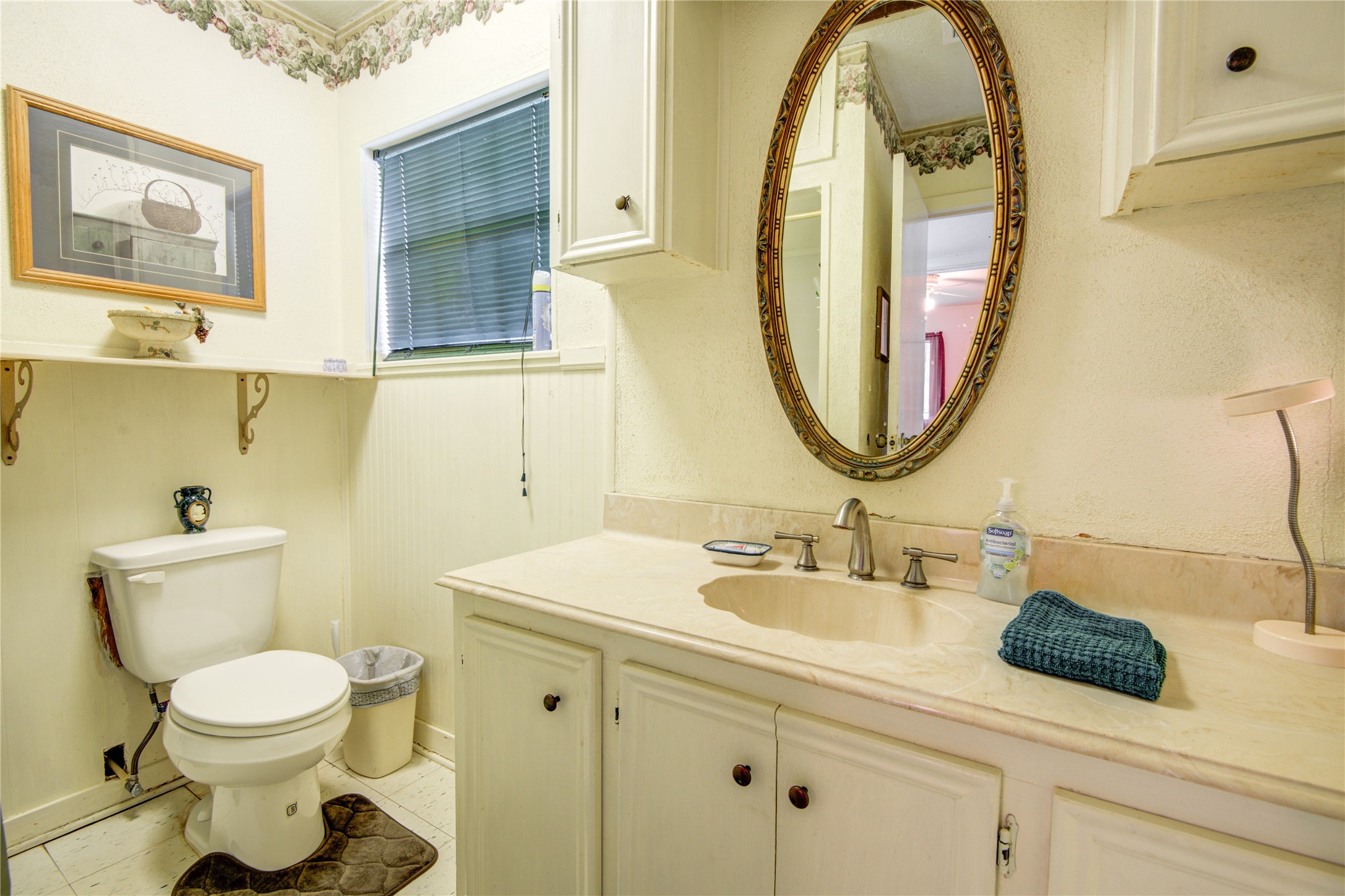 1414 West 9th Street Freeport, TX 77541 - Photo 30 of 50 a bathroom with a toilet sink and mirror