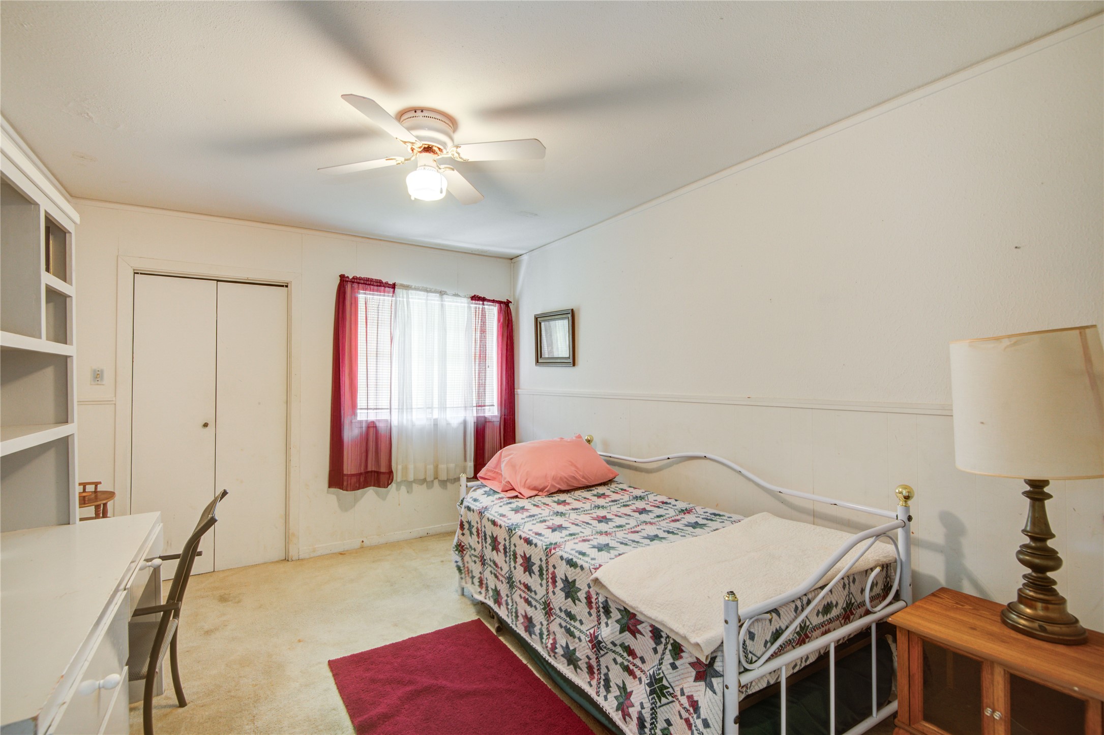 1414 West 9th Street Freeport, TX 77541 - Photo 32 of 50 a bedroom with a large bed and a chandelier