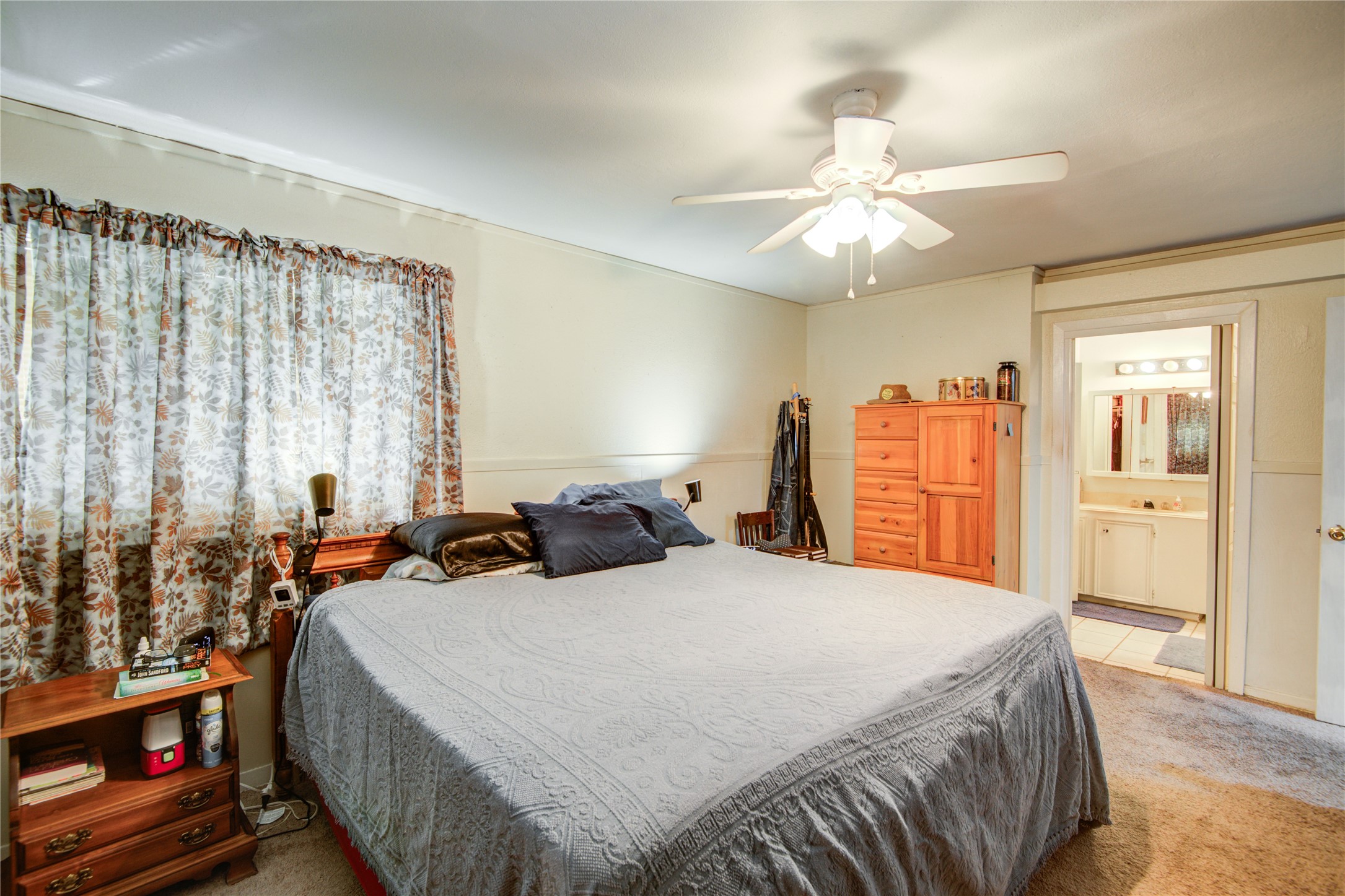 1414 West 9th Street Freeport, TX 77541 - Photo 35 of 50 a bedroom with a bed and a chandelier