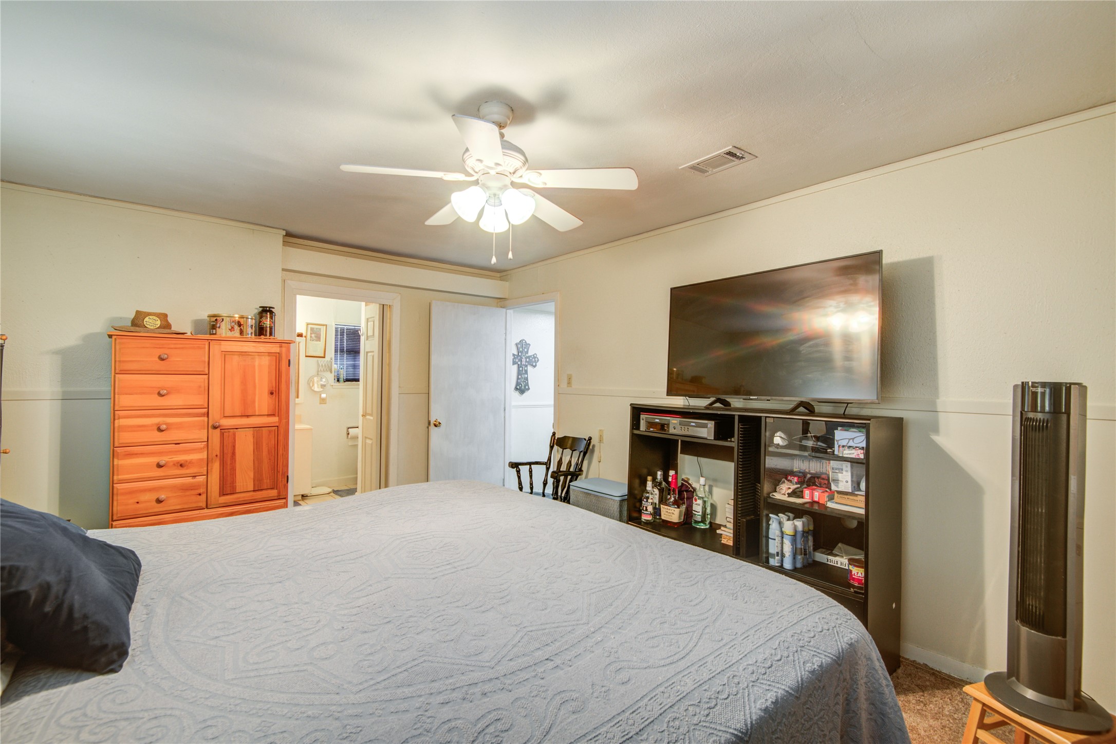 1414 West 9th Street Freeport, TX 77541 - Photo 36 of 50 a bedroom with a bed and a flat screen tv