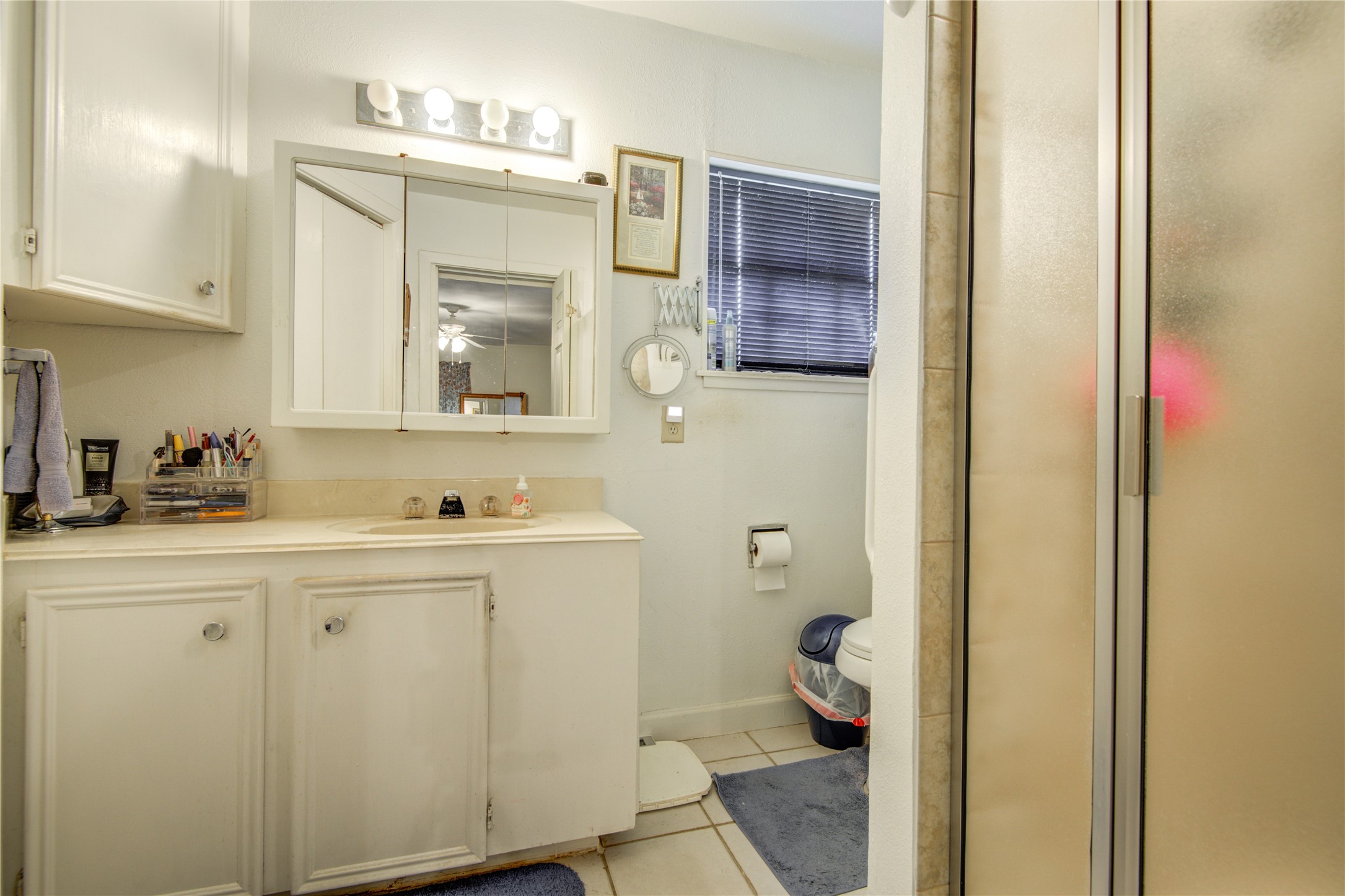 1414 West 9th Street Freeport, TX 77541 - Photo 37 of 50 a bathroom with a sink and mirror with toilet