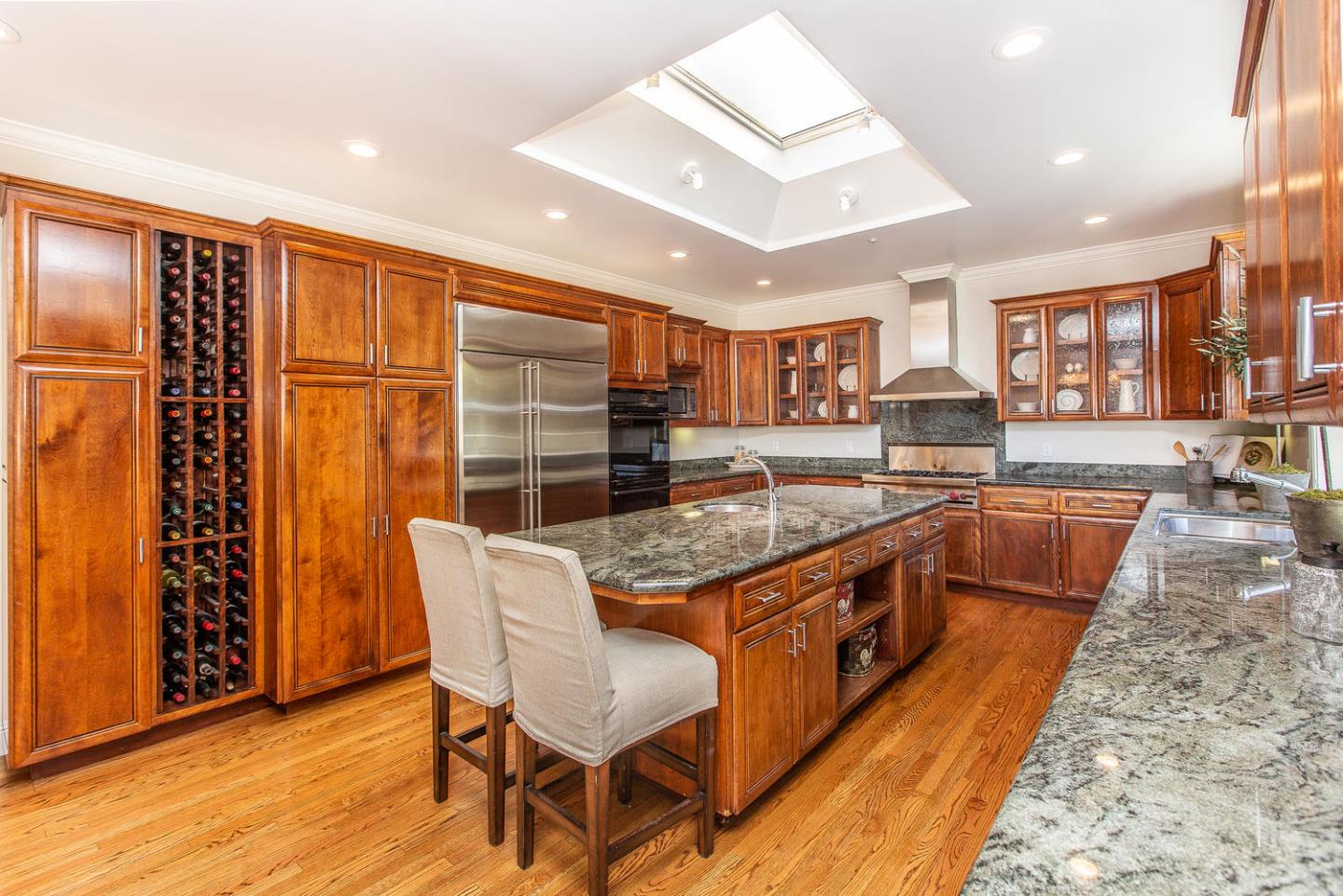 730 Chateau Drive Hillsborough, CA 94010 - Photo 19 of 48 a large kitchen with stainless steel appliances granite countertop a stove and a large window