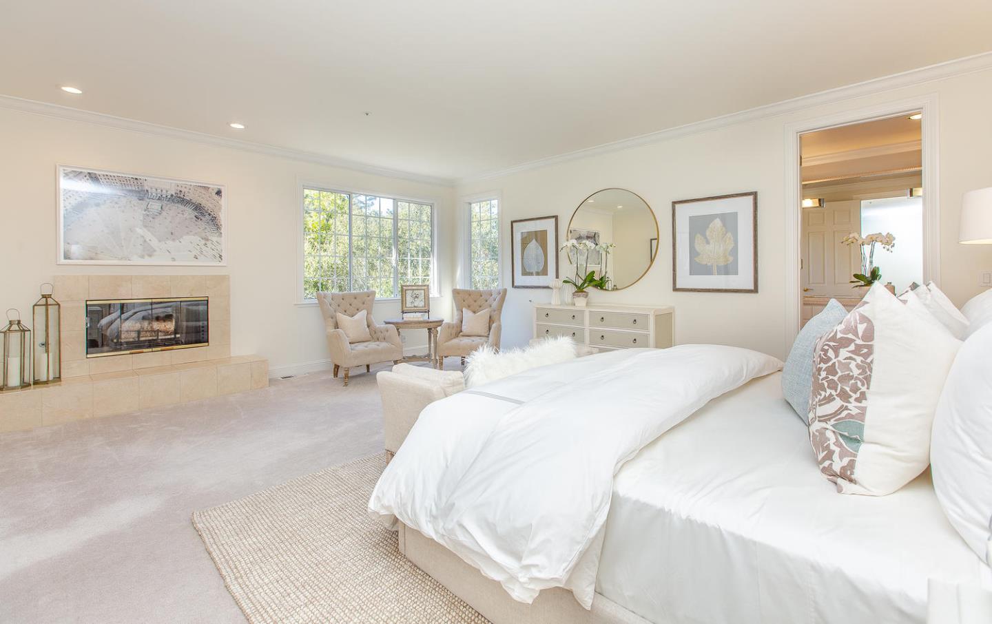 730 Chateau Drive Hillsborough, CA 94010 - Photo 22 of 48 a bedroom with a bed large mirror and a large window