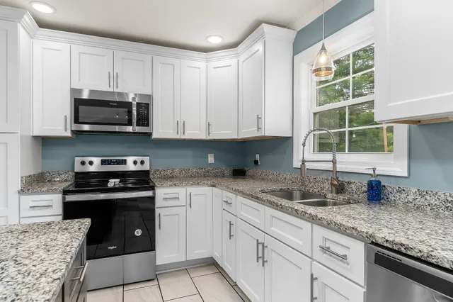 a large white bed in a blue room