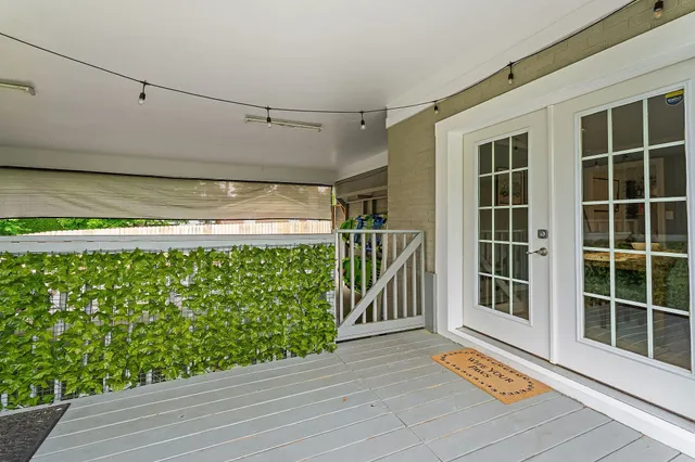 a view of a chair and table in backyard of the house
