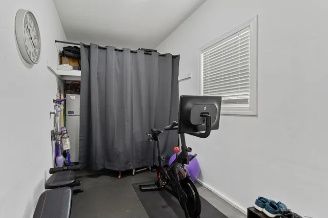 a view of a house with a small yard and palm trees