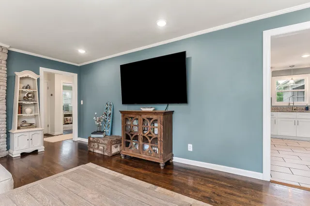 a kitchen with granite countertop white cabinets a table and chairs in it
