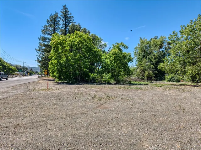a view of a field with trees in background