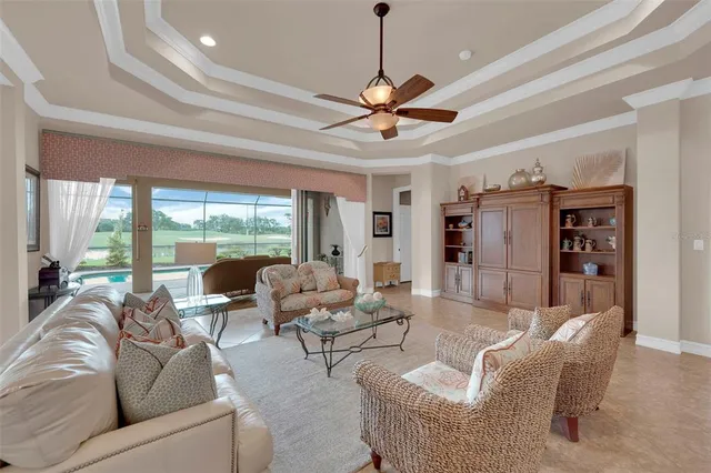 a living room with furniture ceiling fan and a rug