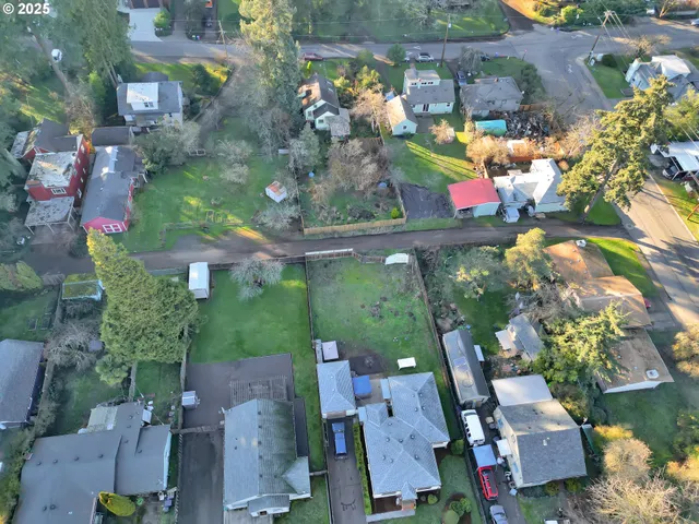 an aerial view of a house with a yard basket ball court