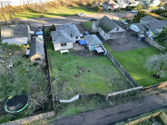 an aerial view of a house with garden space and street view