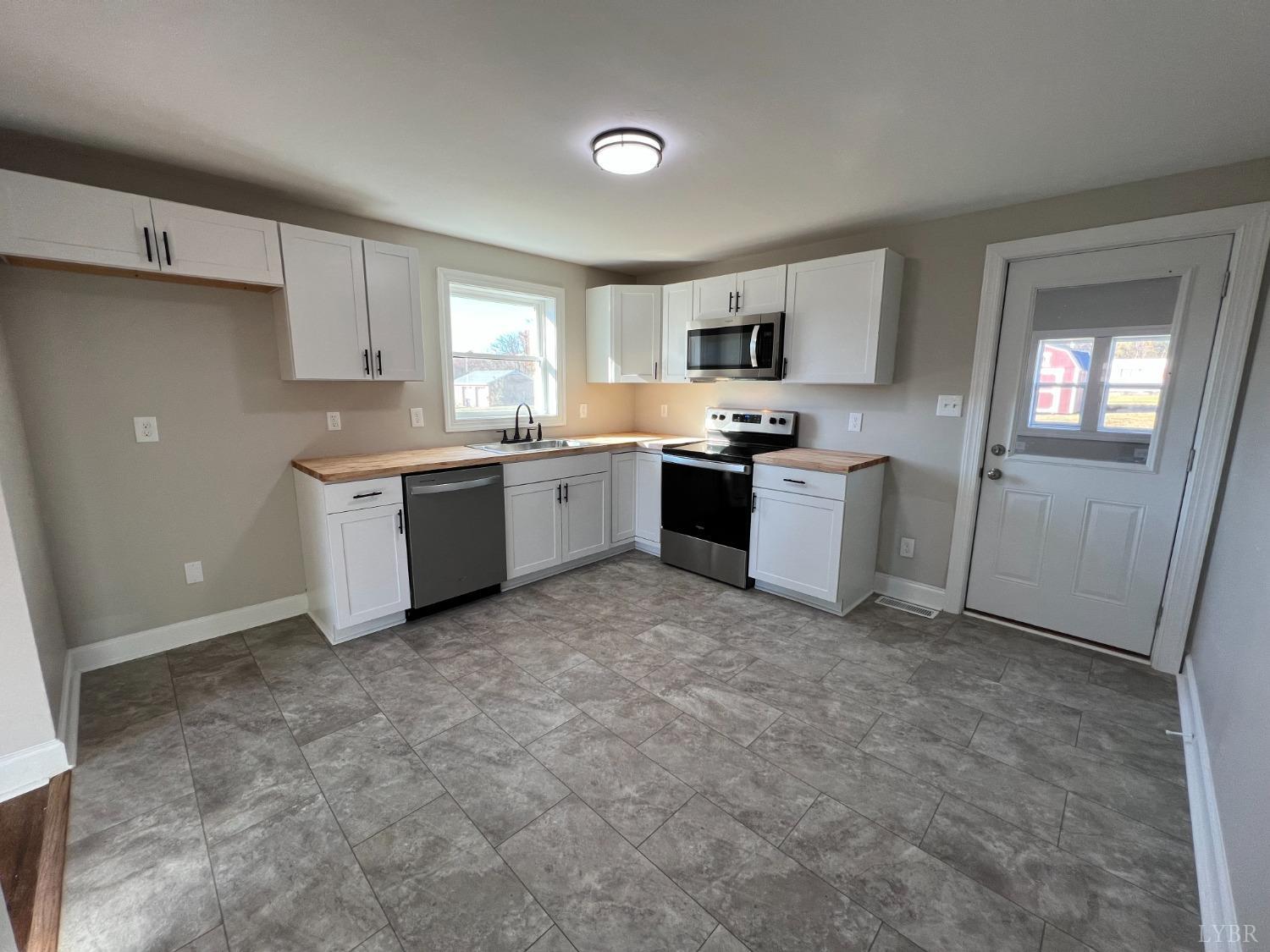 2178 Cedar Gate Road Madison Heights, VA 24572 - Photo 16 of 31 a kitchen with cabinets and stainless steel appliances