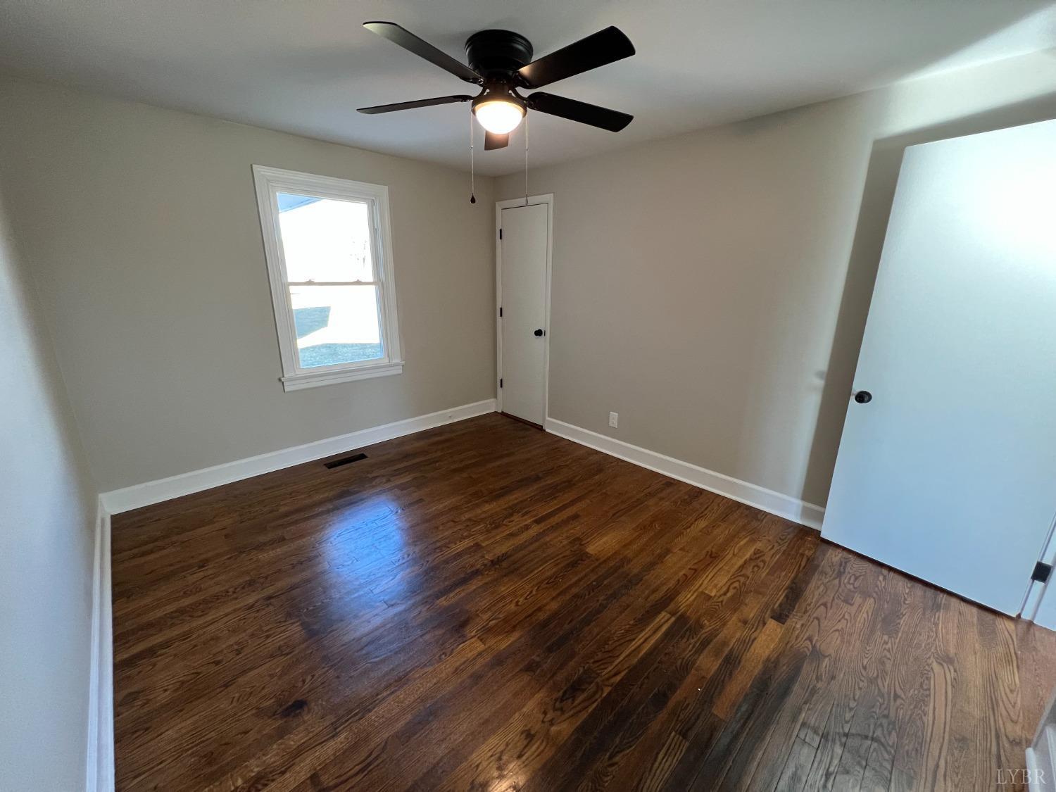 2178 Cedar Gate Road Madison Heights, VA 24572 - Photo 28 of 31 a view of an empty room with wooden floor and a window