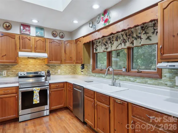 a kitchen with a sink cabinets and wooden floor