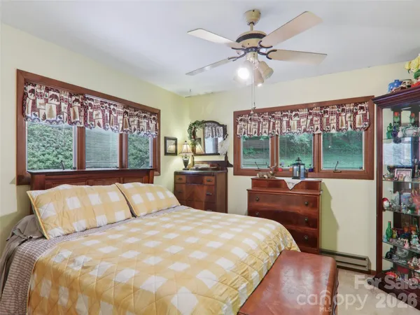 a bed room with furniture and window