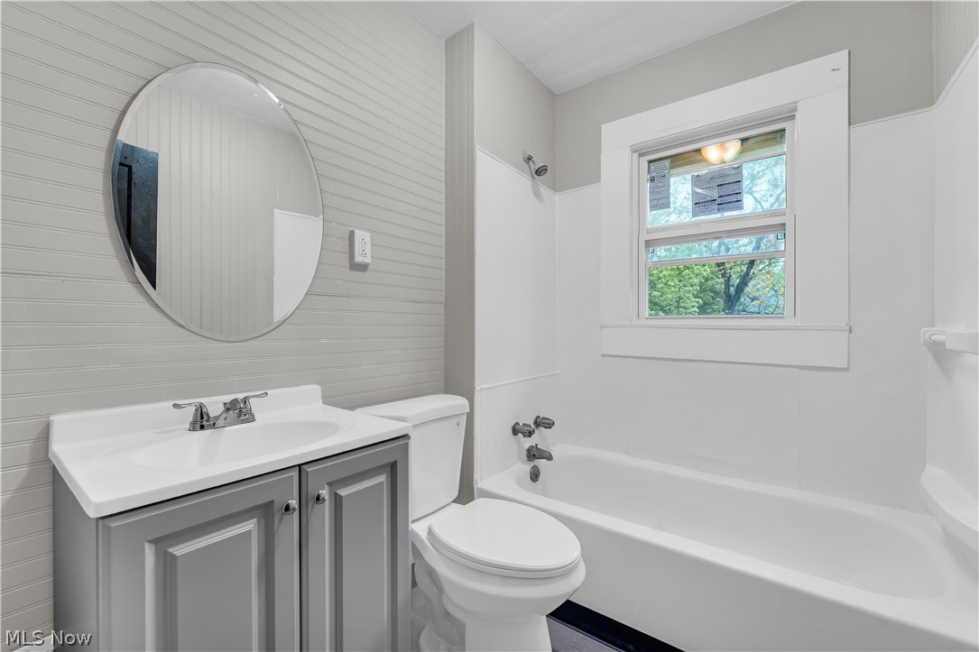1144 East 145th Street, Unit 1/RIGHT Cleveland, OH 44110 - Photo 17 of 20 Bathroom featuring a single vanity with gray cabinetry, a white countertop, and a chrome faucet