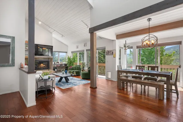 a kitchen with stainless steel appliances a sink a stove and a wooden floor