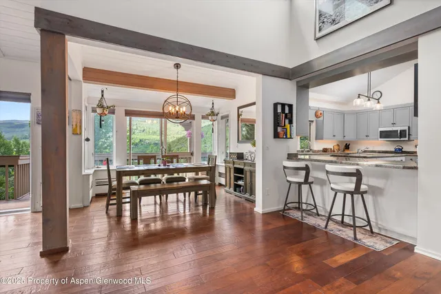 a bedroom with a large bed and a large window with outer view