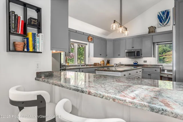 a bathroom with a double vanity sink and mirror with shower