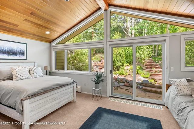 a bathroom with a granite countertop sink a large mirror and shower