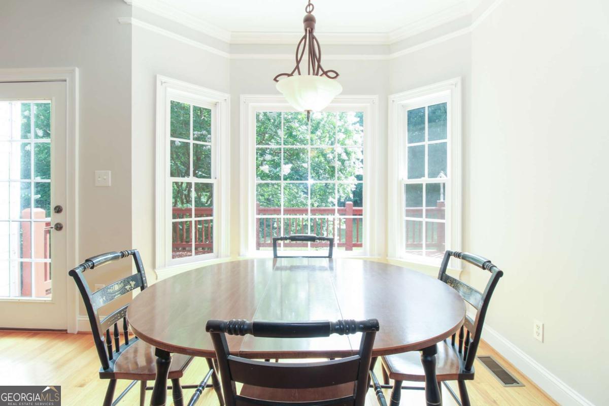1031 Spring Lake Drive Bishop, GA 30621 - Photo 14 of 18 a dining room with furniture window and wooden floor