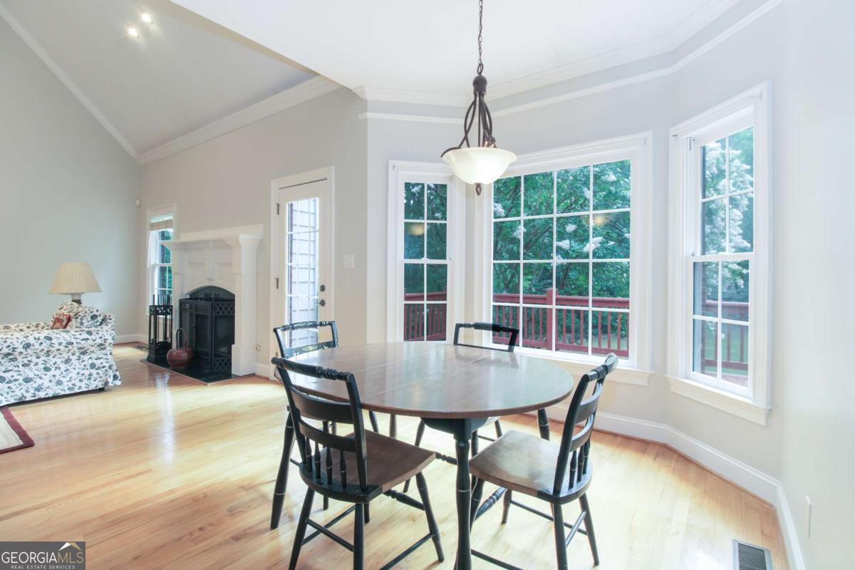 1031 Spring Lake Drive Bishop, GA 30621 - Photo 15 of 18 a dining room with furniture a chandelier and wooden floor