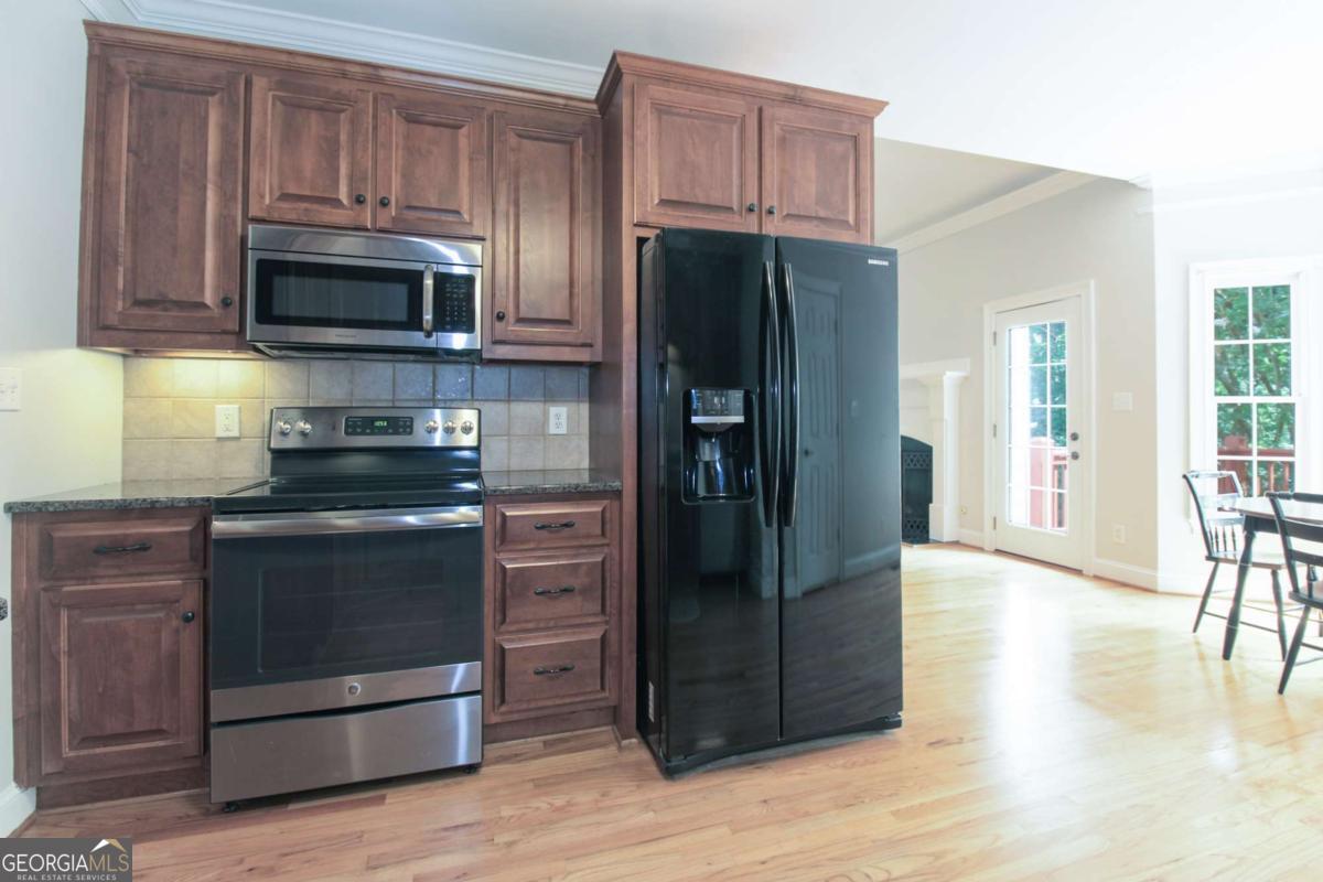 1031 Spring Lake Drive Bishop, GA 30621 - Photo 16 of 18 a kitchen with stainless steel appliances granite countertop a refrigerator stove and microwave