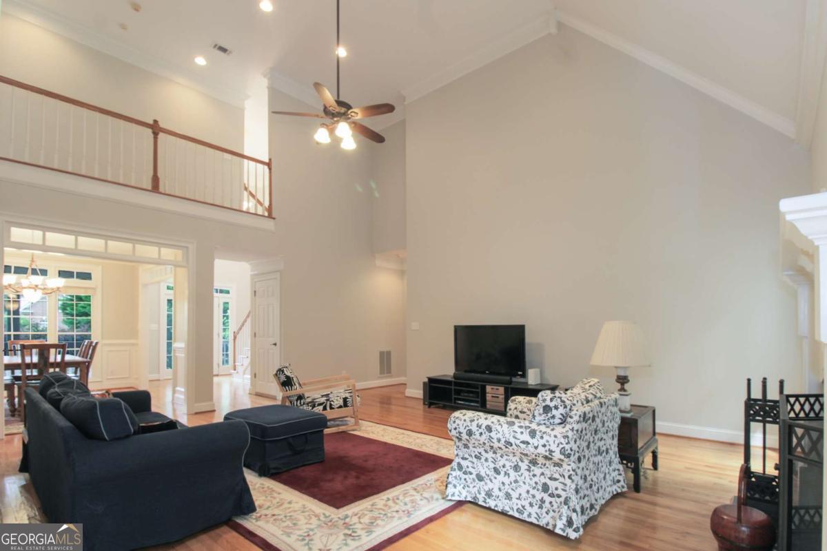1031 Spring Lake Drive Bishop, GA 30621 - Photo 5 of 18 a living room with furniture a flat screen tv and a large window
