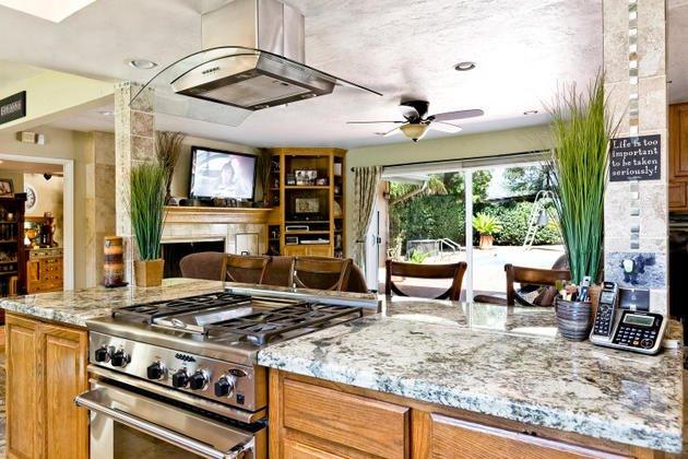 1732 South Rice Road Ojai, CA 93023 - Photo 11 of 28 a kitchen with a stove a sink and a wooden cabinets