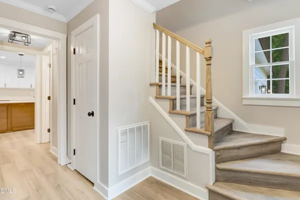 a large kitchen with stainless steel appliances kitchen island granite countertop a refrigerator a stove and a sink with wooden floor